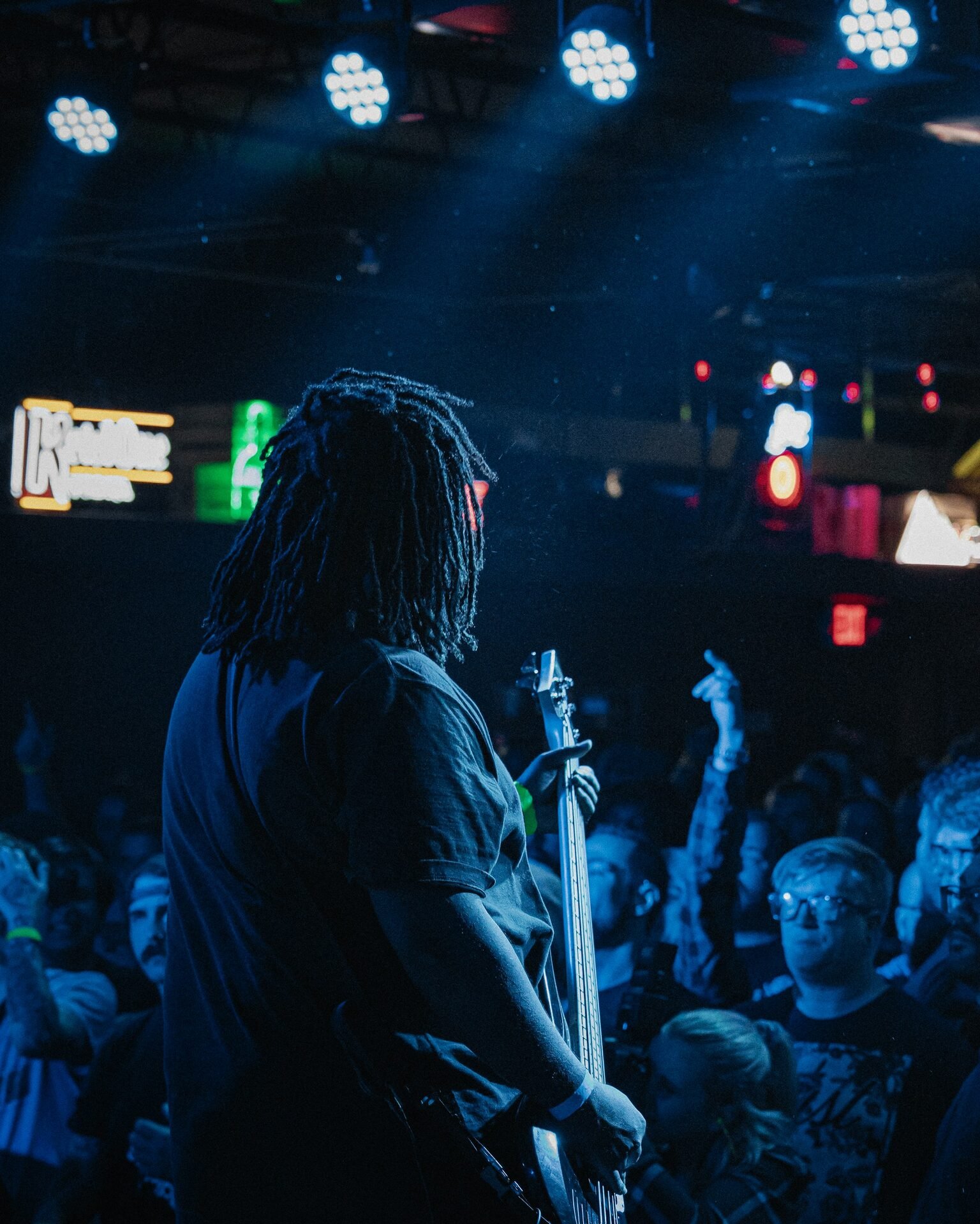 Concert crowd bathed in warm amber stage lighting